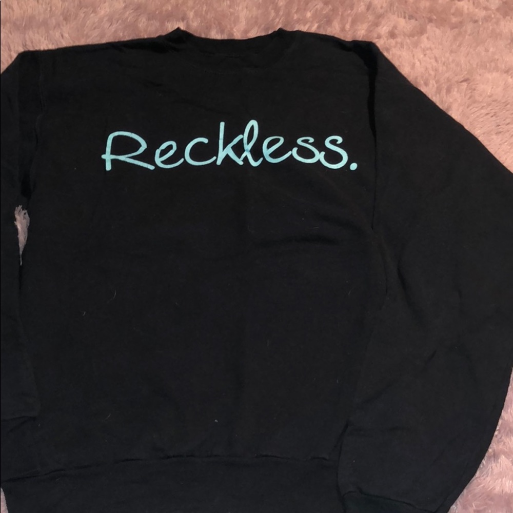 Hanes pullover that says “reckless.”